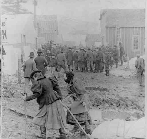 Women-pulling-a-sled-loaded-with-provisions-through-the-streets-of-Skagway-Alaska-in-1898-pint...jpg