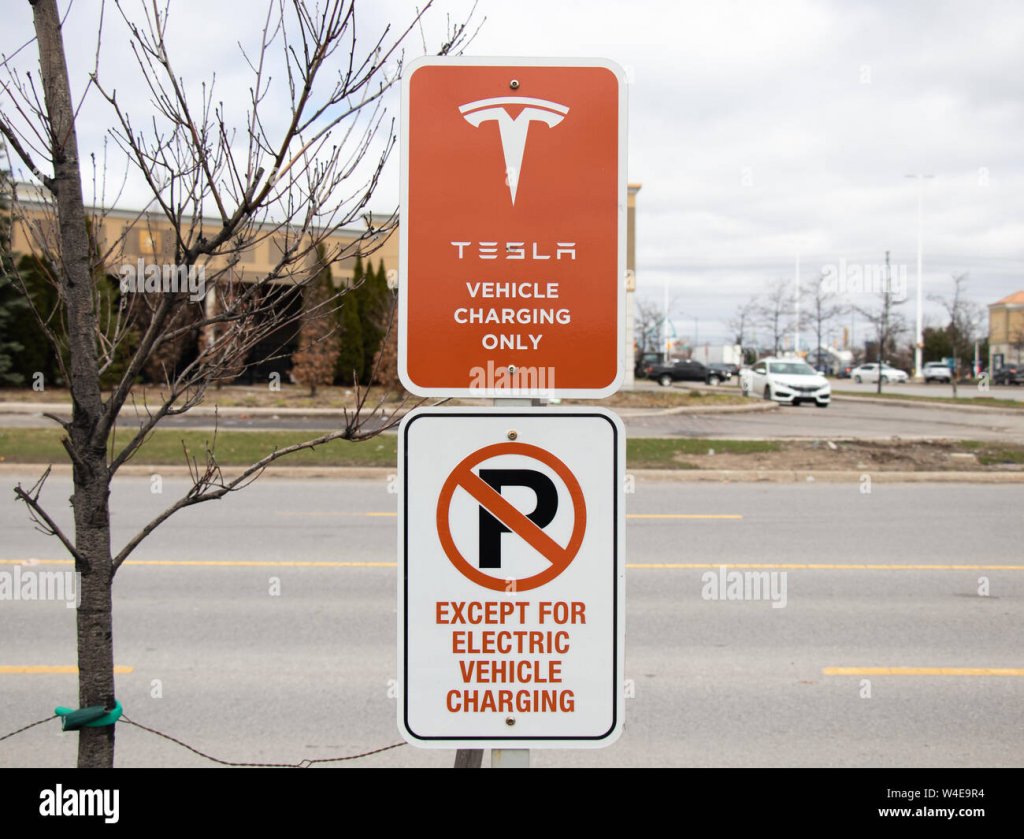 tesla-vehicle-charging-only-sign-and-no-parking-except-for-electric-vehicle-charging-sign-at-v...jpg