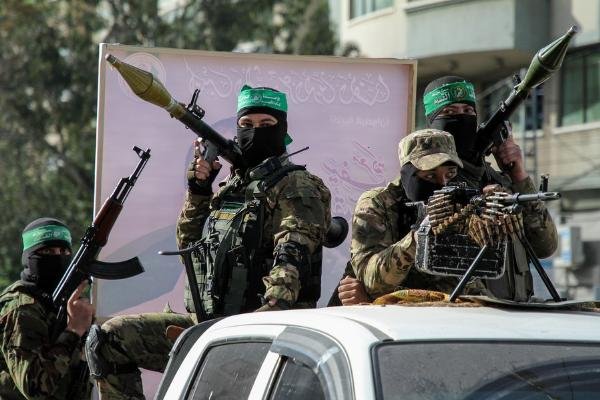 hamas_militants_toyota_hilux_trucks_during_military_parade_to_show_off_force_ceasefire_with_is...jpg