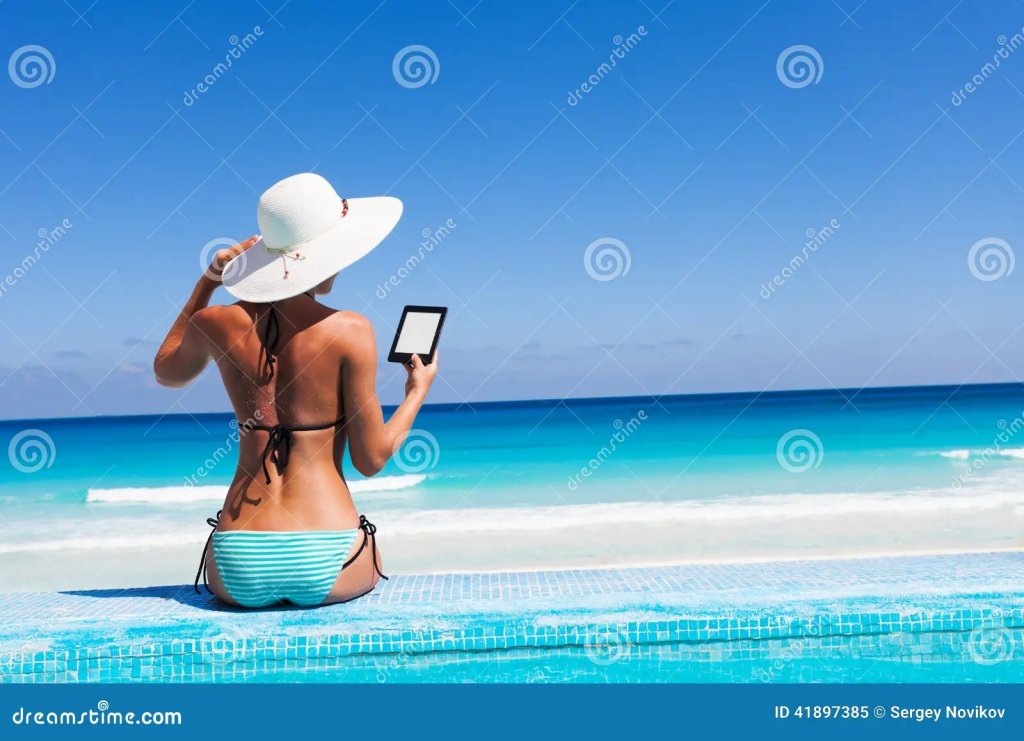 girl-white-hat-reads-kindle-beach-beautiful-woman-back-holds-41897385.jpg